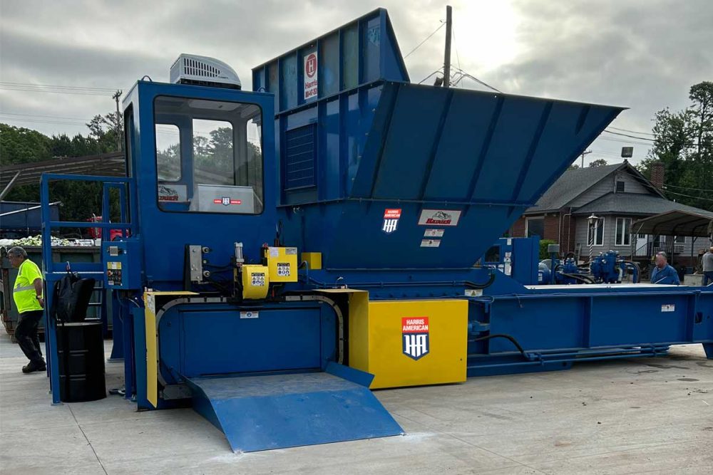 Blue And Yellow Harris American Co. Baler Outside