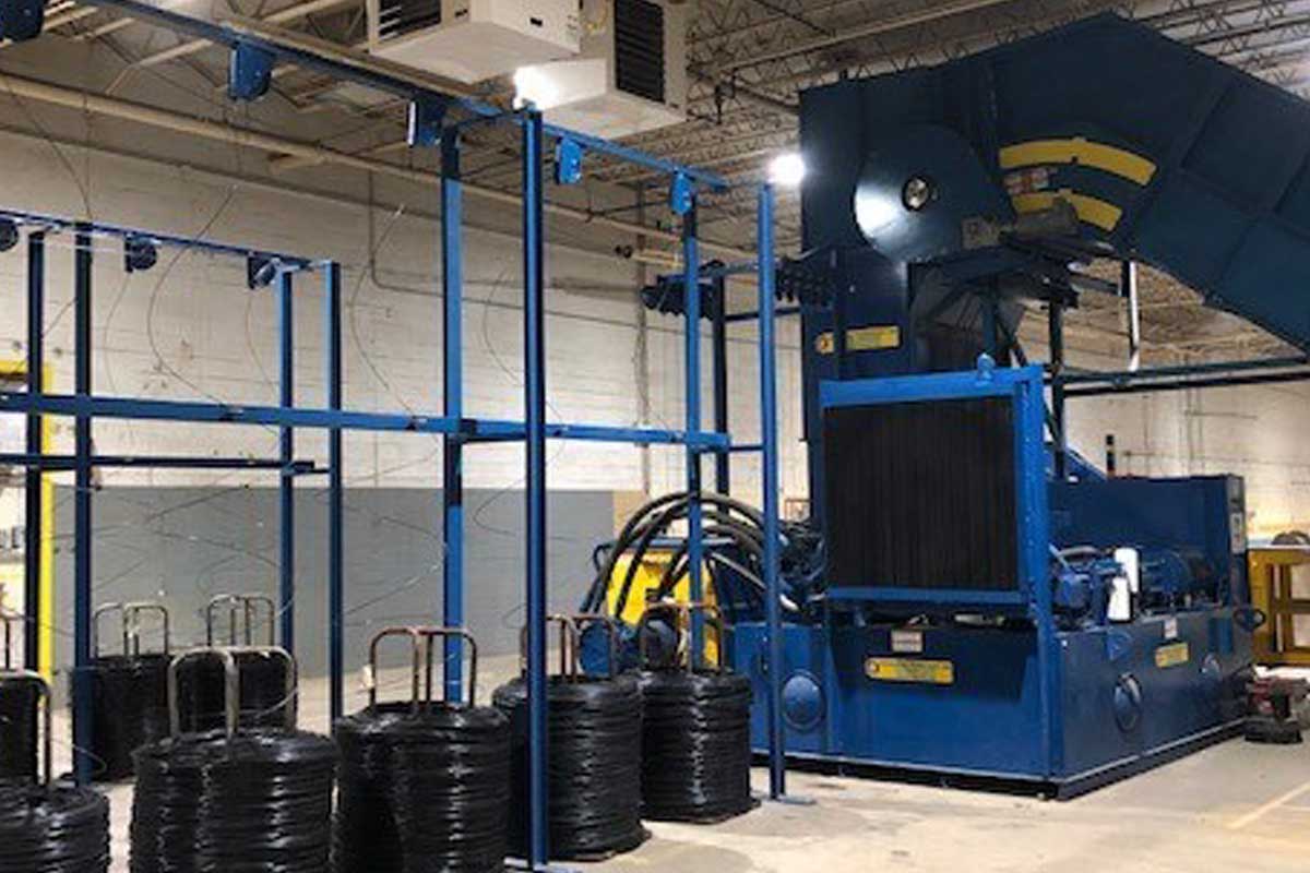 Harris American Co. Baler Next To Spools Of Wire Or Cable