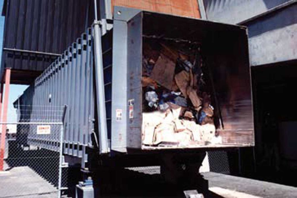 A Large Dump Truck With A Large Pile Of Garbage.